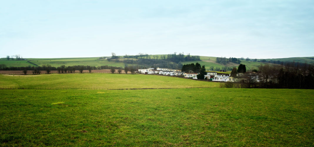 A view across fields to Courthill Park set in the open countryside